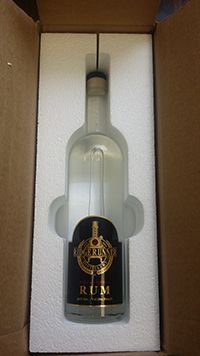 Foam box insert designed to hold glass liquor bottle. Made from EPS foam, compare to Styrofoam.
